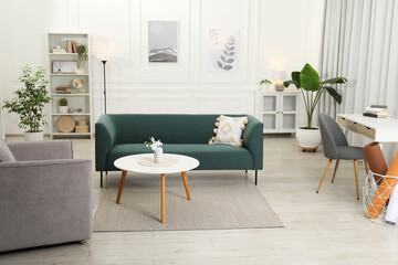 Stylish living room interior. Comfortable sofa, armchair and coffee table indoors