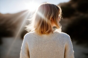 Sunlit solitude: woman enjoying nature's warmth