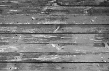 Weathered black and white wood plank or board floor.