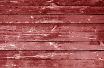 Weathered red stained wood plank or board floor.