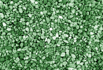 Pebble stones background. Green toned.