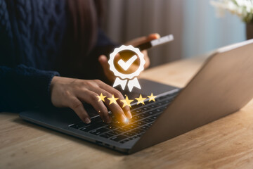A close-up view of a person's hands typing on a laptop, with an overlay of award symbols, representing excellence in customer feedback and business quality in a modern workspace.