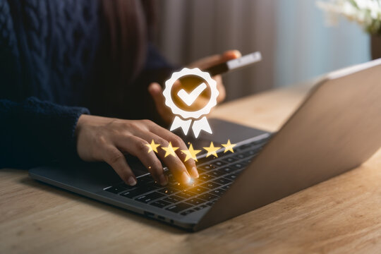 A close-up view of a person's hands typing on a laptop, with an overlay of award symbols, representing excellence in customer feedback and business quality in a modern workspace.