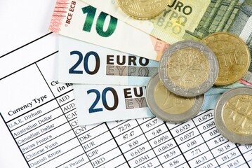 euro banknotes and coins on the table
