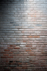 Obraz premium A brick wall with a light shining on it