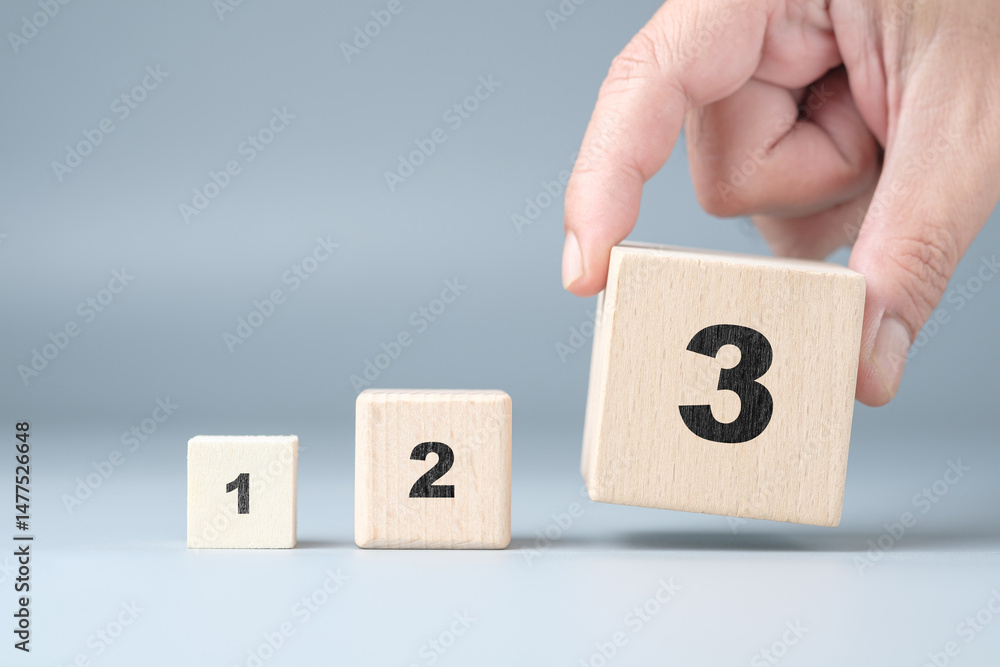Fototapete Hands arrange wooden cubes numbered 1 2 3 in order from smallest to largest, importance of following the steps