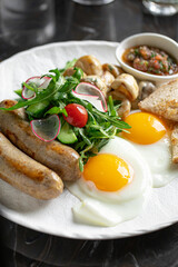 Portion of breakfast with sausages and fried eggs