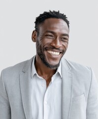 Obraz premium A confident professional man smiling warmly in a light gray blazer and white shirt