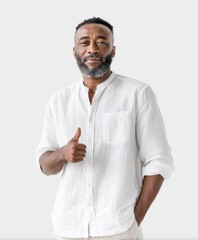 Fototapeta premium Confident Man Giving Thumbs Up in Casual White Shirt