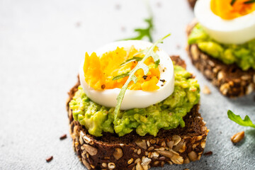 Whole grain bread with avocado and boiled eggs.
