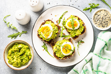 Whole grain bread with avocado and boiled eggs.