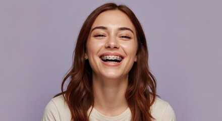 Portrait of a smiling woman with braces showing a beautiful, happy smile.