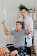 Fototapeta premium Patient with weak arm muscles doing light dumbbell exercises during physical therapy to regain strength and support physical recovery.