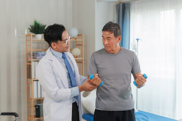 Fototapeta premium Patient with weak arm muscles doing light dumbbell exercises during physical therapy to regain strength and support physical recovery.