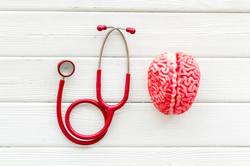 Human brain model with red stethoscope, top view. Mental health concept.
