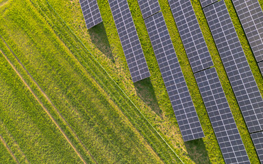 Top-down view of the Solar panels on the green field 