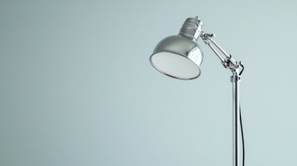 Simple, modern desk lamp against a muted background
