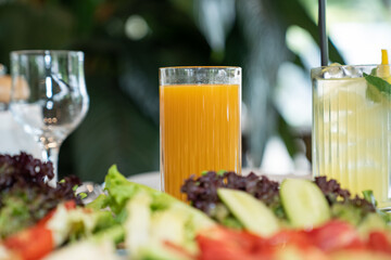 Close up view of a glass of fresh orange juice served on a restaurant table.