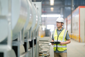 asian male engineer woking on digital tablet in factory with  Industrial fan impeller