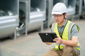 asian male engineer woking on digital tablet in factory with  Industrial fan impeller