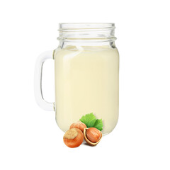 Nut milk in glass jar and hazelnuts isolated on white