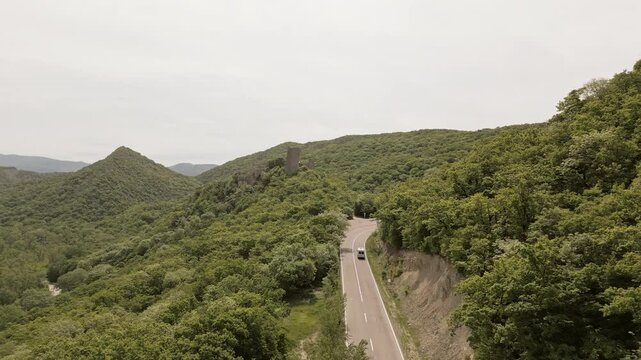 Aerial view car drive on asphalt curvy road by Ujarma Fortress &ndash; Ancient Hilltop Royal Citadel and Strategic Stronghold of the Iberian Kings in Kakheti, Georgia