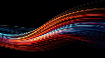 Abstract light painting with flowing, colorful lines of red, orange, and blue against a black background.