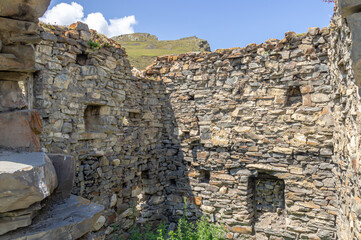 A dilapidated medieval architectural complex located high in the mountains. The largest mountain...