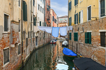 Rio del Ghetto canal with laundry lines between old houses, in the Jewish Ghetto, Cannaregio district, 