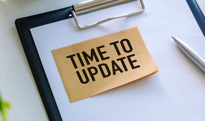 A small piece of paper with the words Time to Update written on it