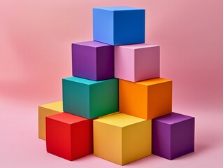 Obraz premium Colorful Cubes Stacked in Pyramid Shape on Pink Background