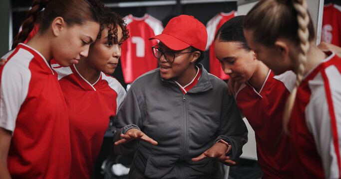 Women, coach and discussion with soccer players for match or game plan in locker room. Female people, coordinator or talking with football group for team formation, ideas or sport strategy together