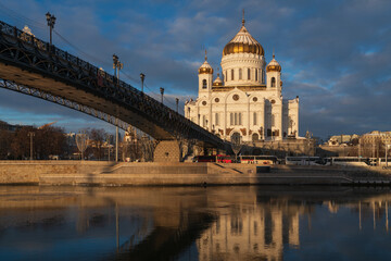 Fototapeta premium View of the Cathedral of Christ the Savior and the Patriarchal Bridge from the Beresnevskaya embankment of the Moskva River on a sunny winter day, Moscow, Russia