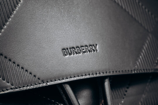 Paris, France - 23 February 2025: Closeup of Burberry black leather handbag with embossed logo and signature check pattern detail