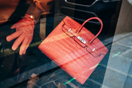 Paris, France - 23 February 2025: Herm&egrave;s Birkin crocodile leather handbag, gold hardware, luxury accessory in boutique window