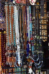 Rosary beads made of natural stones hanging in a shop window