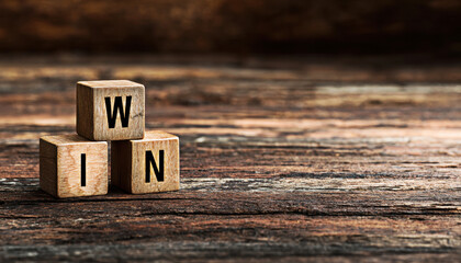 Three wooden blocks feature the letters W, I, and N, symbolizing success and achievement.