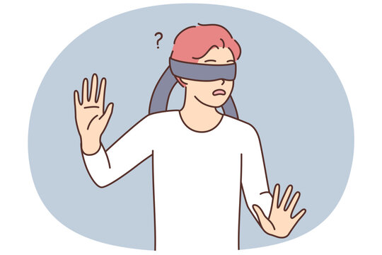 Frightened teen boy blindfolded trying to grope road of action in blind