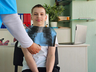 Boy undergoing x-ray examination in a medical office with a healthcare
