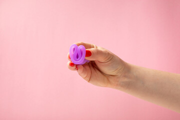 Menstrual cup on a bright background. Sanitary napkins, tampons and menstrual cup.Concept of critical days, menstruation.feminine hygiene product. Women health concept.Premenstrual syndrome.Copy space