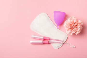 Menstrual cup on a bright background. Sanitary napkins, tampons and menstrual cup.Concept of critical days, menstruation.feminine hygiene product. Women health concept.Premenstrual syndrome.Copy space