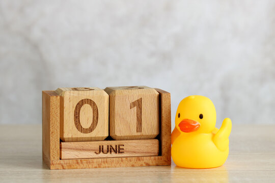 Wooden calendar showing june 1st with rubber duck celebrating children's day