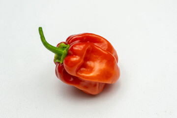 ripened red habanero peppers (capsicum chinense) on rustic table. Very hot mexican peppers close up