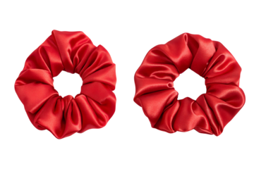 Two bright red scrunchies made from shiny satin fabric on transparent background