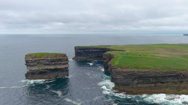 Aerial view of stunning Downpatrick Head coastal landmark with iconic Dun Briste sea stack. Dramatic cliffs and waves. Raw beauty of Ireland's west coast. Wild Atlantic Way Signature Discovery Point.