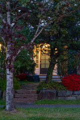 Entrance of luxury house with nice spring blossom landscape at night in Vancouver, Canada, North America. April 2025.