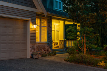 Entrance of luxury house with nice spring blossom landscape at night in Vancouver, Canada, North...