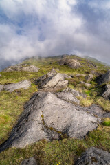 The breathtaking view showcases majestic rocks alongside vibrant greenery, all beneath a dramatic and captivating sky, making it perfect for nature and adventure themes, Carlingford, Ireland