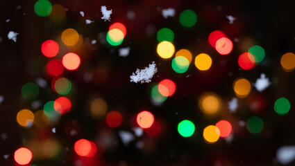 Christmas lights bokeh with falling snowflakes creating a festive and magical atmosphere