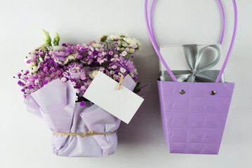 Bouquet of different purple flowers as a gift, white background. Gift for a holiday, Women's Day, Wedding, Mother's Day, March 8.